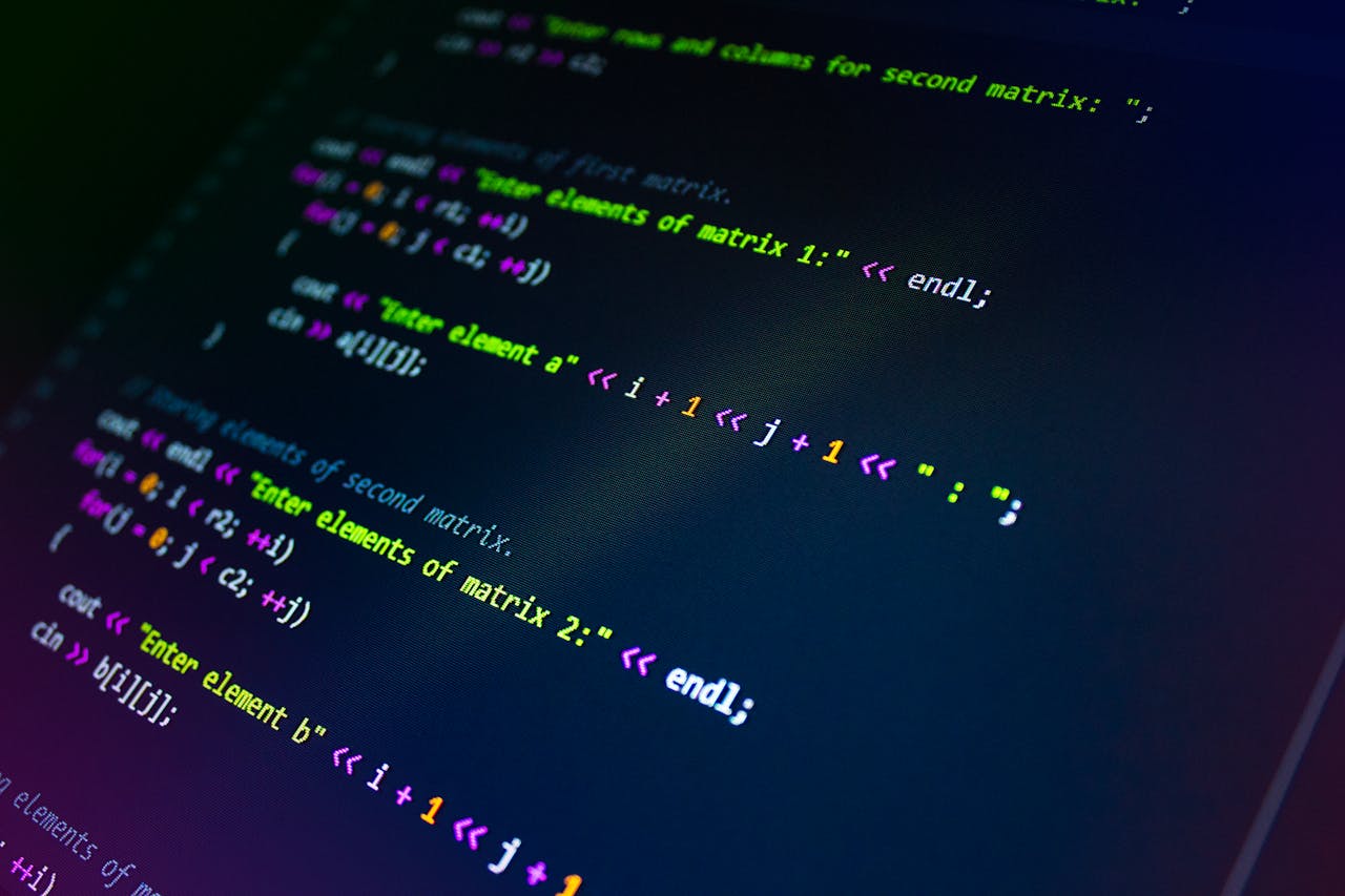 who-we-are Close-up of colorful programming code displayed on a monitor screen.